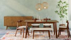 Walmart. Dark wooden dining table, matching chairs and bench, blue painted walls, rug, sideboard, pendants above table