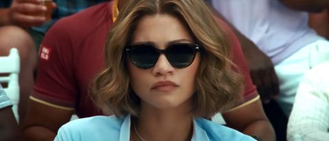 Zendaya looking forward stoically while wearing sunglasses in Challengers.