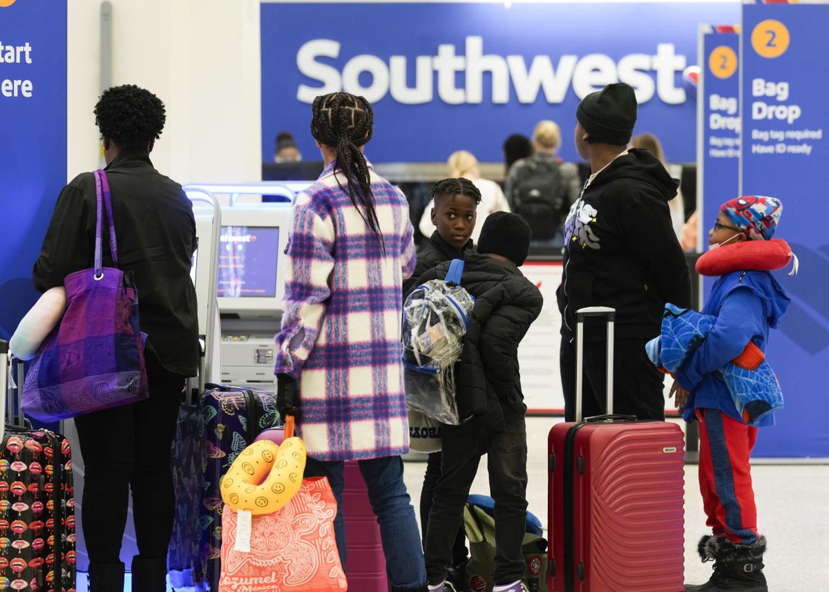 Southwest Airlines passengers queue at baggage check-in at George Bush Intercontinental Airport, Tuesday, Nov. 21, 2023, in Houston