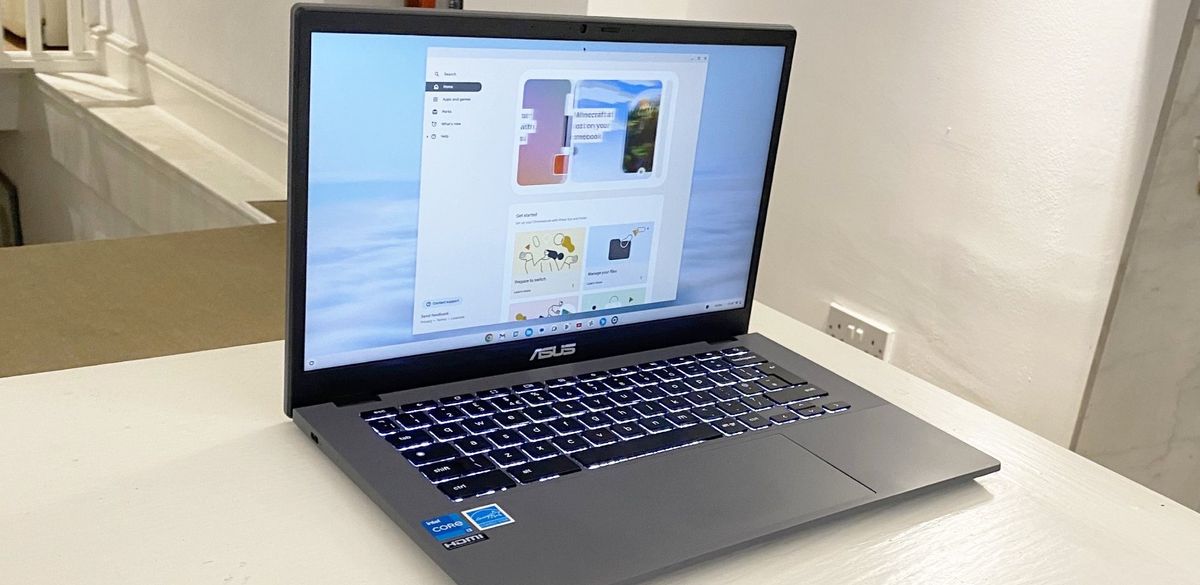 The Asus Chromebook Plus CX34 photographed on a white desk.