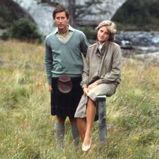 Prince Charles and Princess Diana on honeymoon at Balmoral standing in the grass along the river