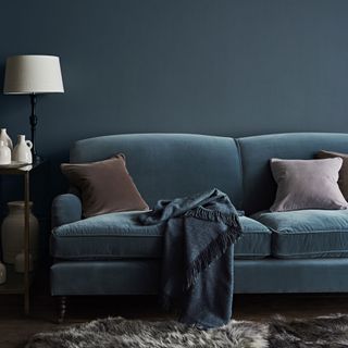 living room with blue wall and sofaset with cushions