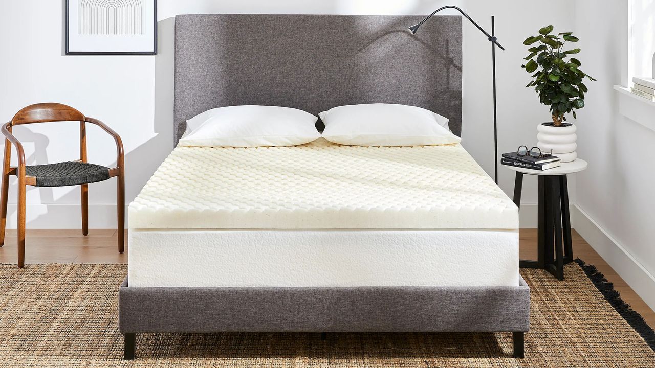 The Molecule CopperWELL Mattress Topper on a mattress in a stylish, modern bedroom.