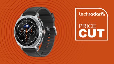 Samsung Galaxy Watch 8 Classic Smartwatch on orange background with TechRadar price cut sign