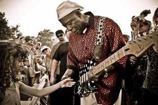 Buddy Guy: "This was shot at the end of the Santa Cruz Blues Festival in 2010. I remember being exhausted but decided nonetheless to follow Buddy into the crowd, where he stopped mid-field in front of this little girl and started playing the guitar with her little finger. I immediately dropped to my knees and it was as if the sea had parted and this amazing image materialized."