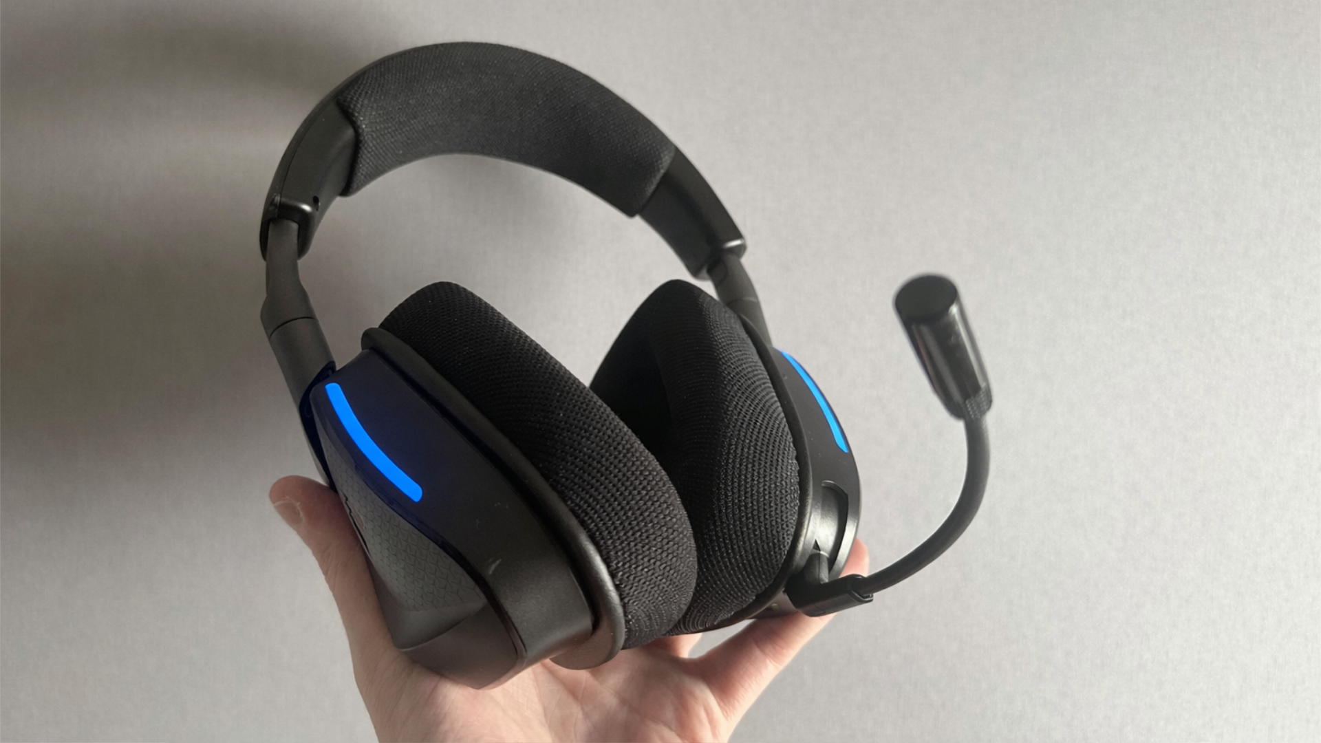 The Void V2 Max Wireless features fabric ear cups and a flexible microphone, with subtle RGB lighting on the ear cups.