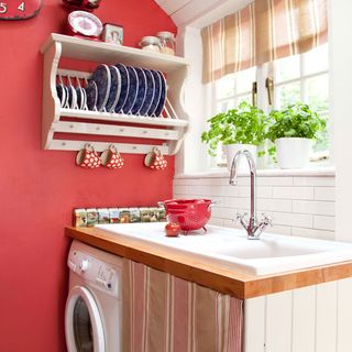 kitchen with red wall and cups