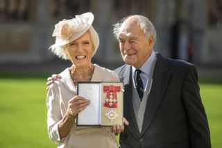 Cookery writer and broadcaster, Mary Berry with her husband Paul Hunnings poses with her medal and star following being appointed Dame Commander of the Order of the British Empire