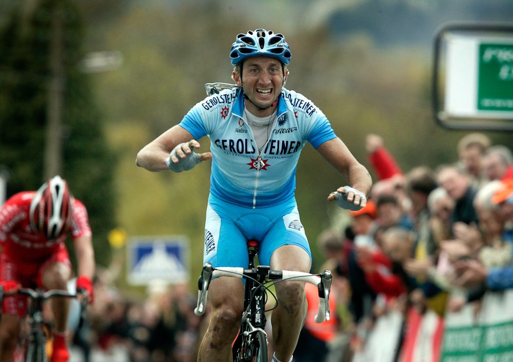 Davide Rebellin of German team Gerolsteiner celebrates in 2004 as he crosses the finish line to win the Fleche Wallonne.