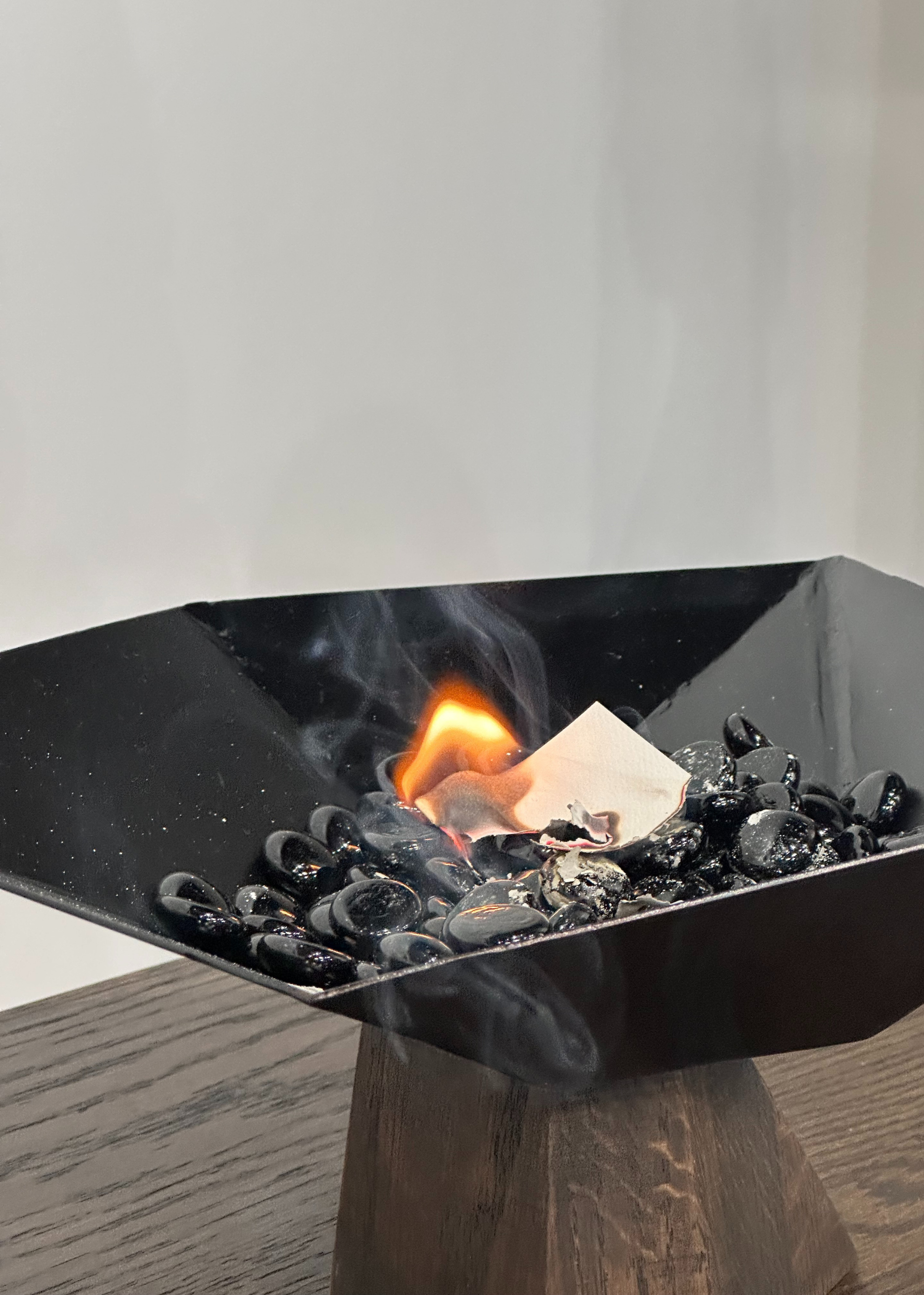 A close-up of a burner bowl on a dark wood table