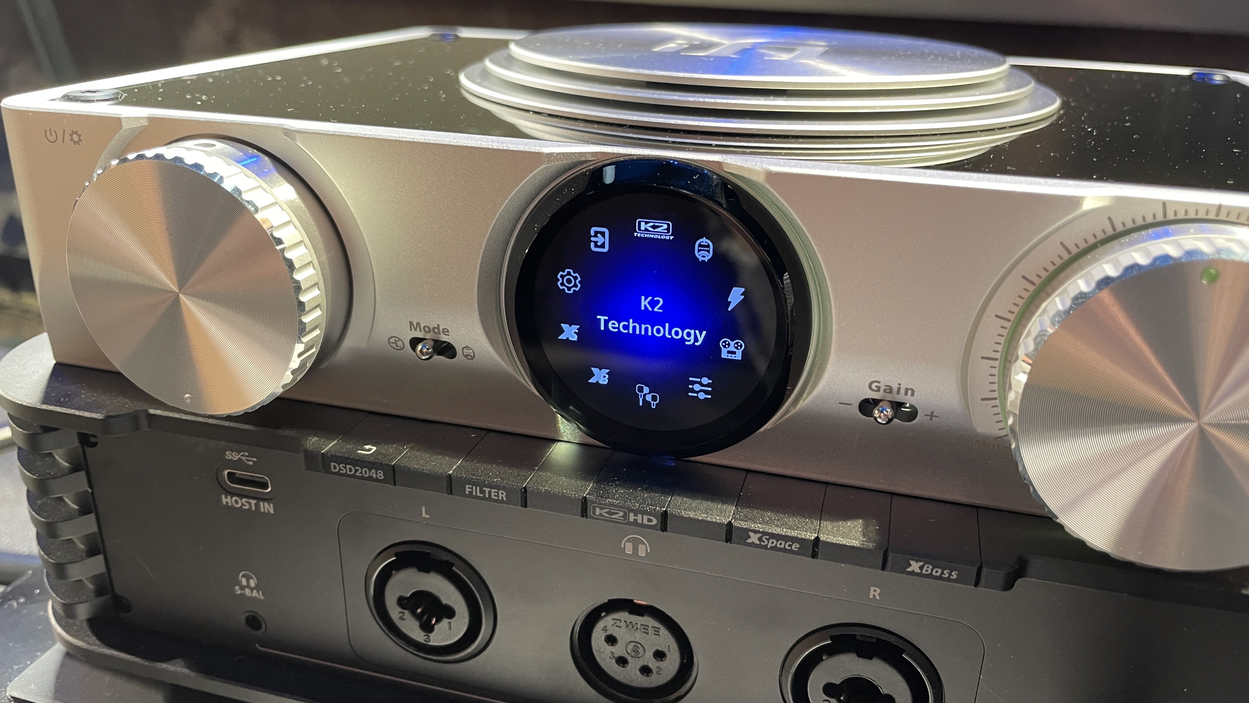 The formidable iFi iDSD Phantom in Tower Bridge, London, used with headphones and illuminating the front panel 