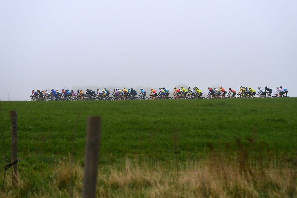 WEVELGEM BELGIUM MARCH 27 A general view of the peloton competing during the 84th GentWevelgem in Flanders Fields 2022 Mens Elite a 2488km one day race from Ypres to Wevelgem GWE22 WorldTour on March 27 2022 in Wevelgem Belgium Photo by Tim de WaeleGetty Images