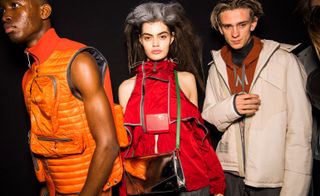 Two male models and one female modelling various styles of clothing at the London Fashion week.