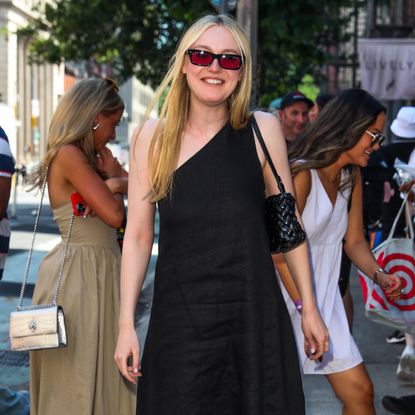 Dakota Fanning wearing a one shoulder linen dress