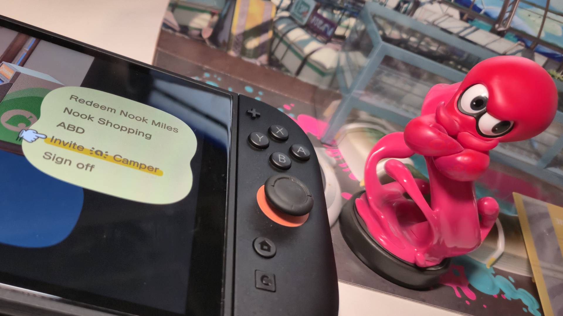 Photo of a pink Octoling amiibo sitting next to the right side of a Nintendo Switch 2.