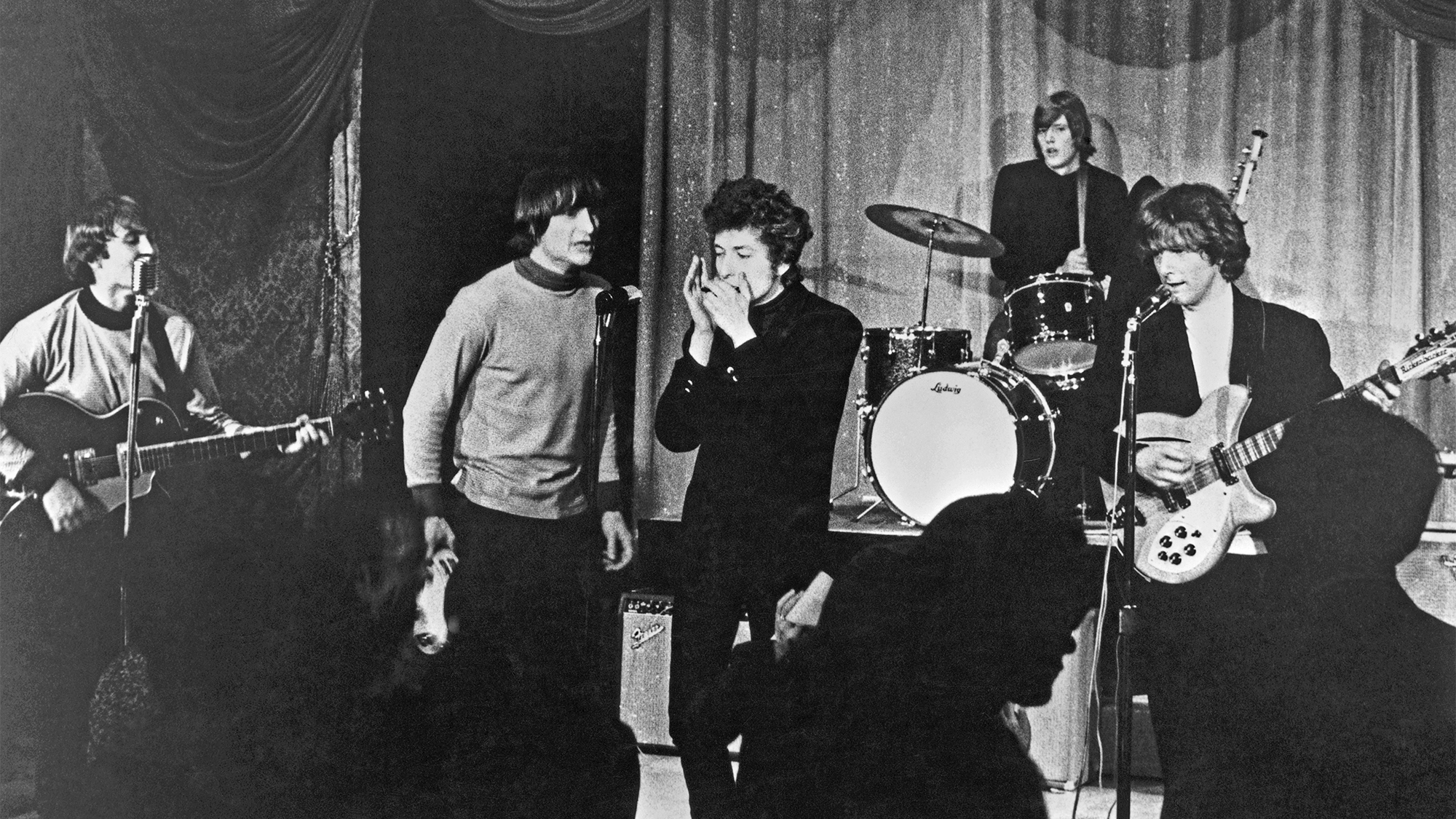 Rock band "The Byrds" performs onstage at Ciro's Nightclub with Bob Dylan on harmonica in 1965 in Los Angeles, California. (L-R) David Crosby, Gene Clark, Bob Dylan, Michael Clarke (on drums), Roger McGuinn.