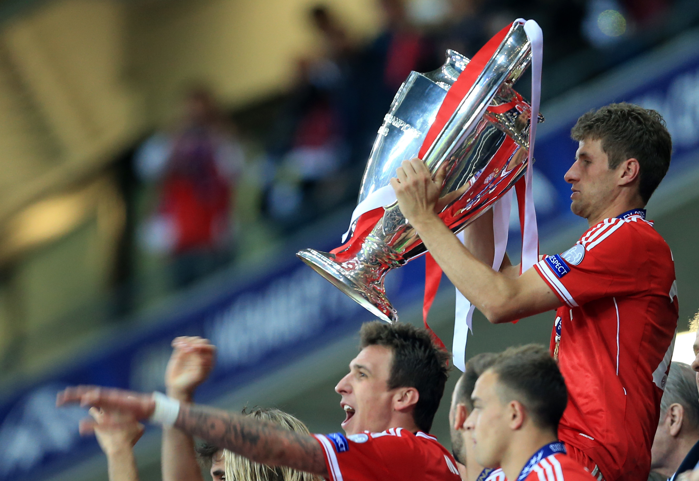 Thomas Muller holds the Champions League trophy after Bayern Munich's win in the 2013 final.