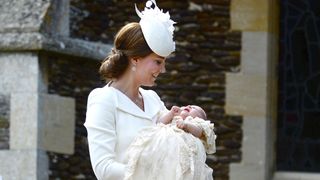 Kate Middleton holding Princess Charlotte at her christening