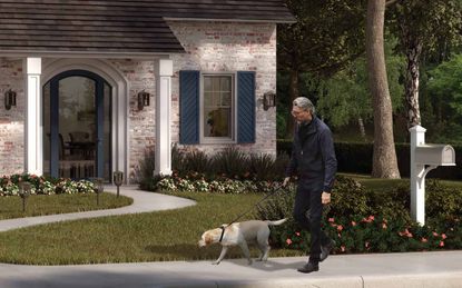 A senior man walking a dog outside a suburban home