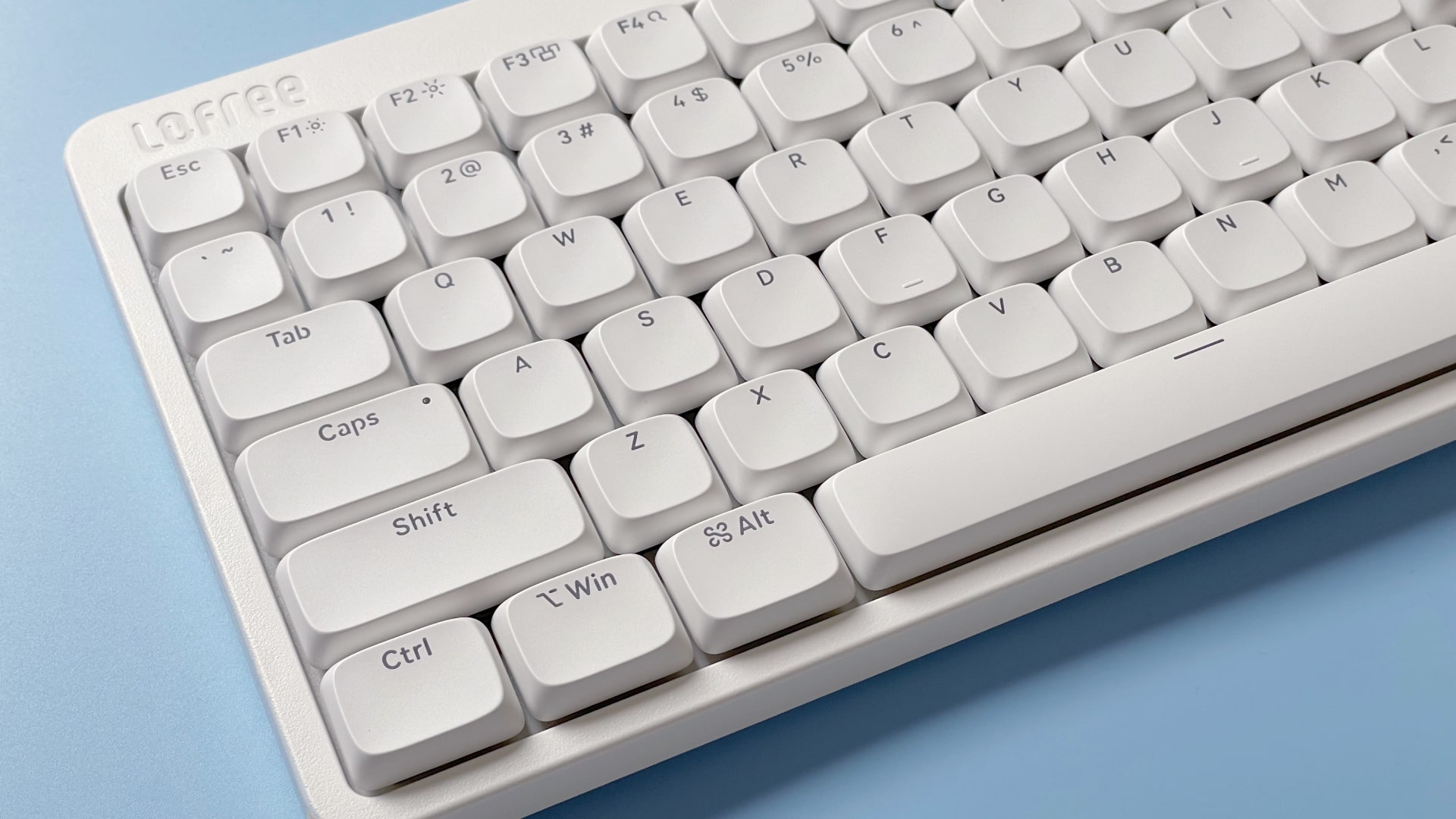 The Lofree Flow Lite mechanical keyboard against a blue background.