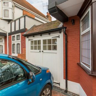 This converted garage has retained the original doors, while creating a functional utility room