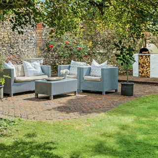 garden with sofa potted plant and wooden storage unit