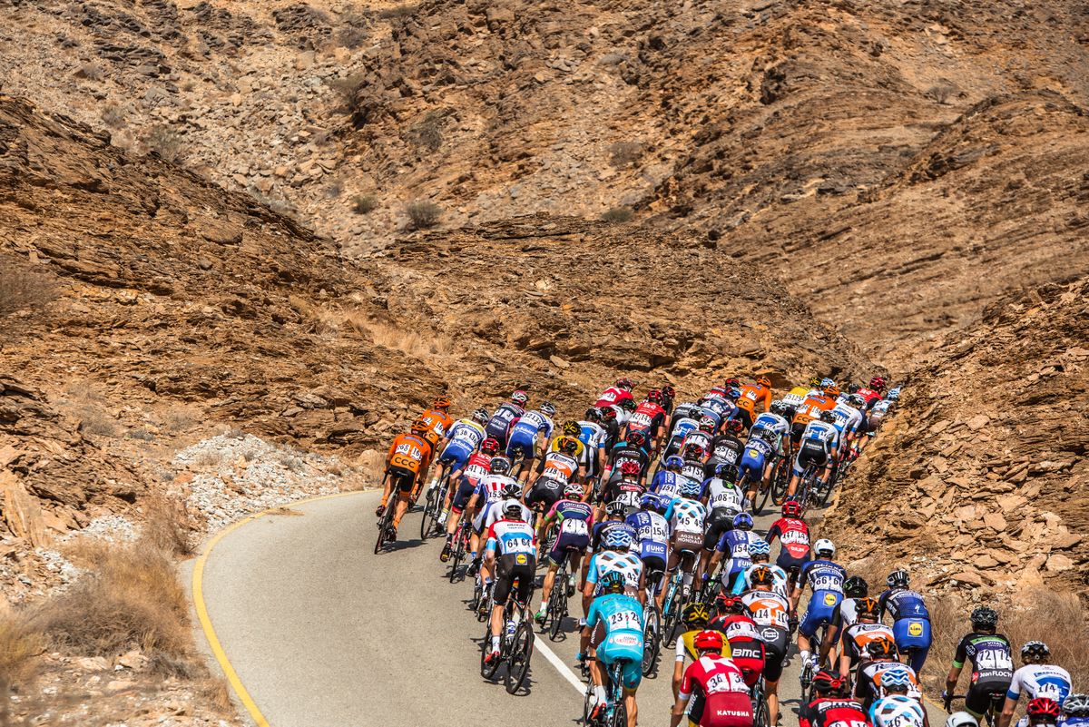 The contrast of the colourful peloton against the Oman landscape