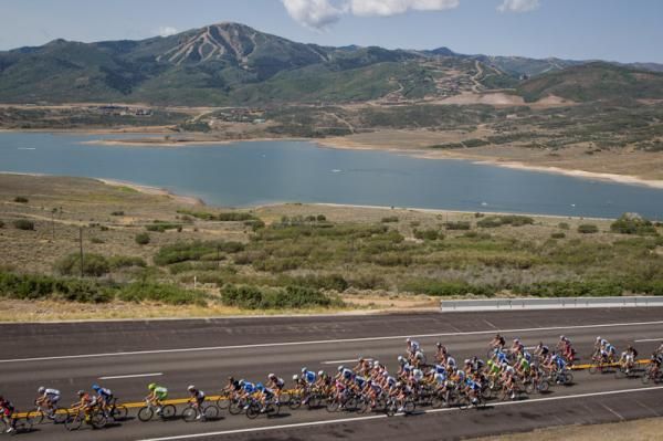 The peloton leaves Park City in the distance