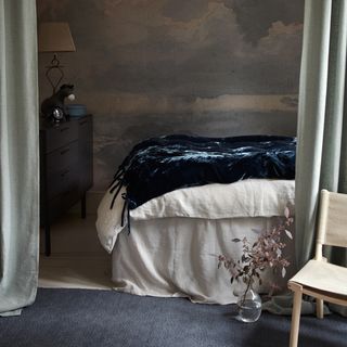 bedroom with printed dusky sky wallpaper on wall