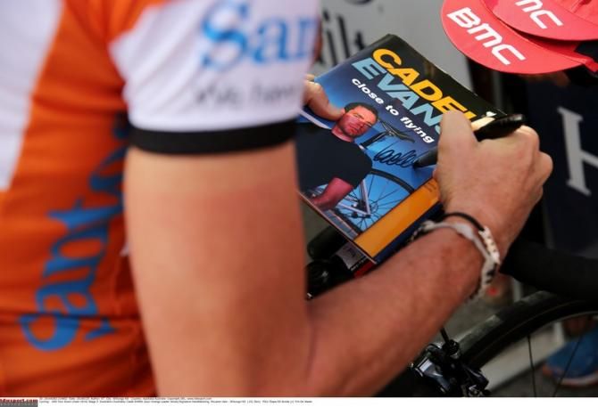 Cadel Evans (BMC) signing copies of his book at the 2014 Tour Down Under
