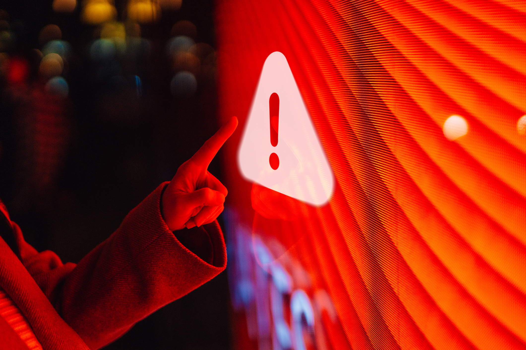 Investor's finger pointing to a red warning sign