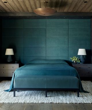 blue bedroom with matching headboard and bedding with a wooden clad ceiling