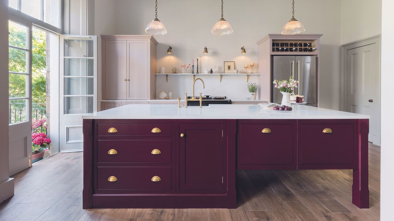 Harvey Jones traditional kitchen with dark red island and light pink cabinetry