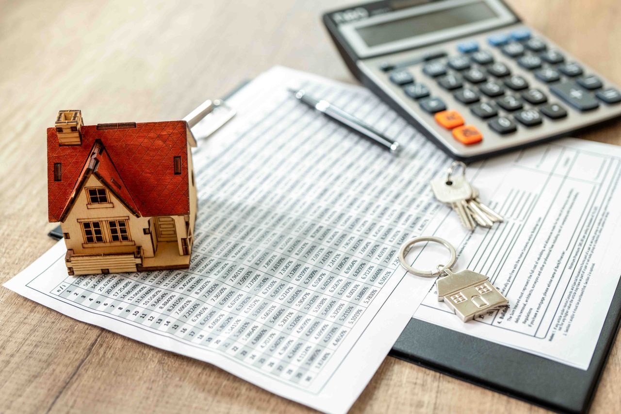 paperwork and a model of a house