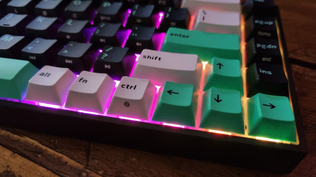 Close ups of the Razer Reclusa X Mini 65% gaming keyboard showing the RGB lighting effect