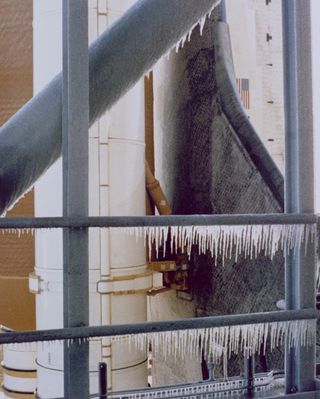Icicles formed on the launch pad and service tower in the evening and early morning hours of January 28, 1986. When freezing temperatures were predicted, all water supply lines were left on slow