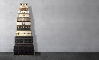 Stack of vintage suitcases against a wall