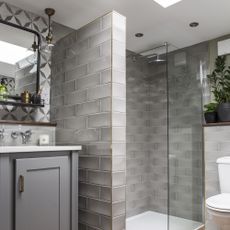 bathroom with grey tiles wall and shower cabin