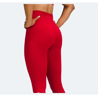 a model wearing the Lululemon Fast and Free Leggings in the color red