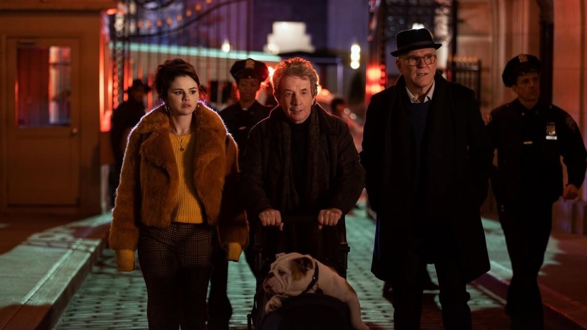 The main cast of Only Murders in the Building walking down a street at night