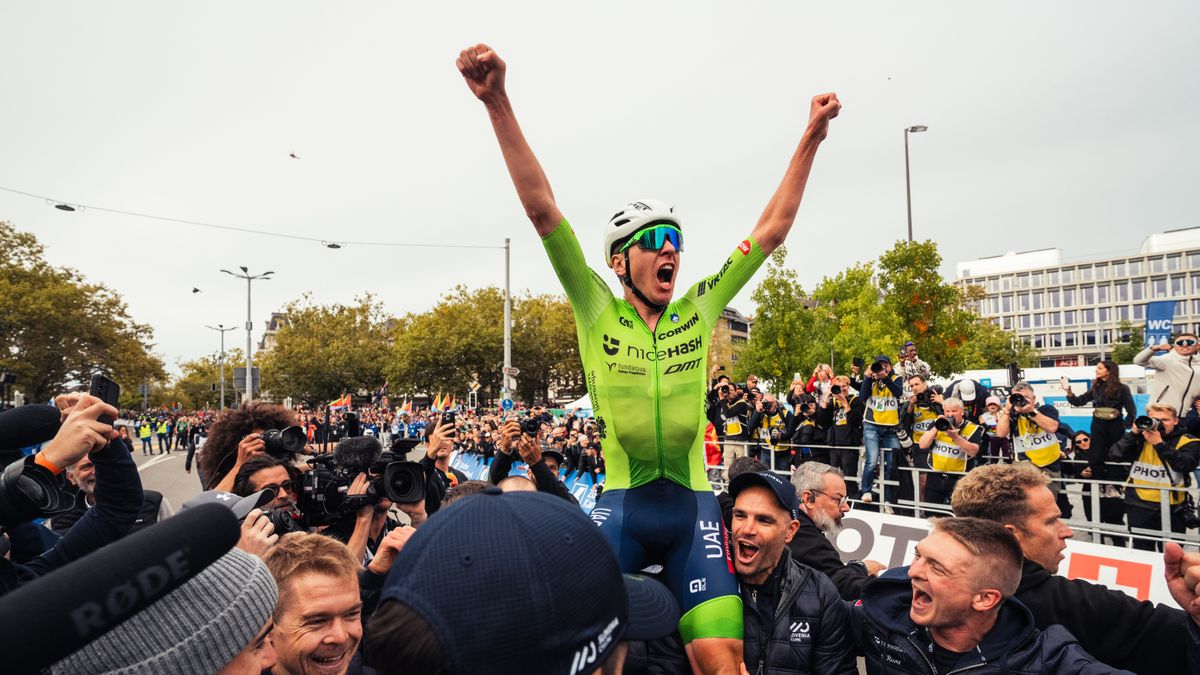 Tadej Pogacar is held aloft with arms raised after winning Worlds in Zurich