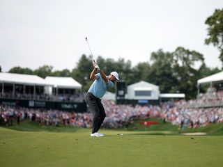 Scottie Scheffler hitting an iron shot at the Travelers Championship