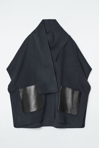 navy cape coat with black leather pockets