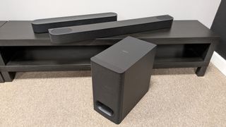 Sonos Beam and Sony Bravia Theater Bar 6 soundbars on dark wooden stand