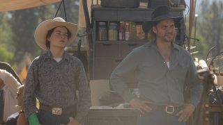 Tate and Kayce standing beside outdoor cooking set-up on Yellowstone