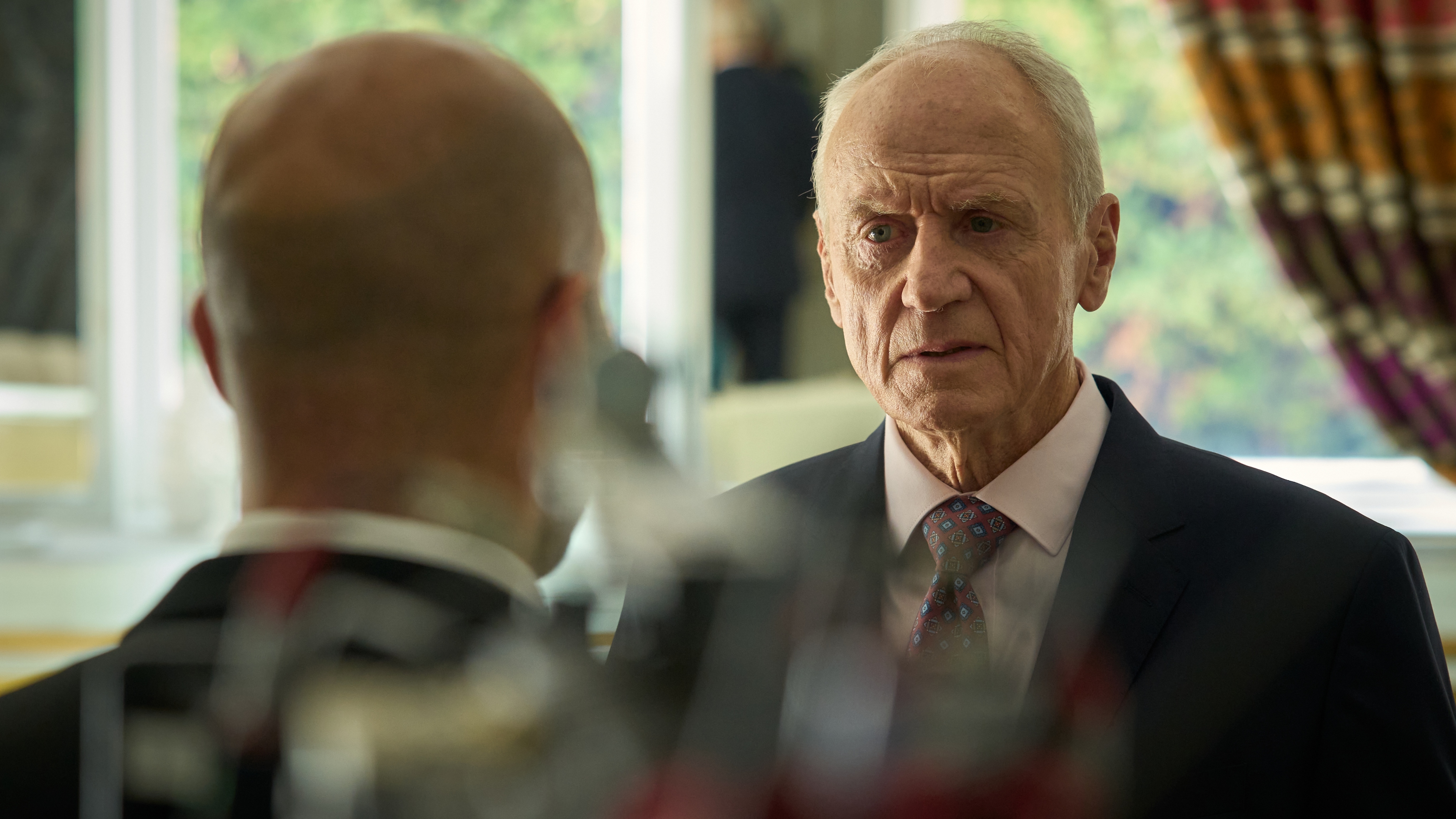 Aaron Cook looks angrily at one of his staff in The Assassin
