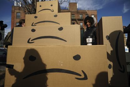 Amazon logo turned into a frown at a protest against Amazon in Long Island City.