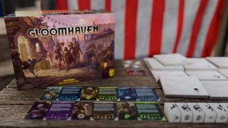 Gloomhaven Second Edition box and components on a wooden table