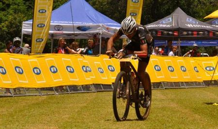 An exhausted winner Jacques Rossouw rolls over the finish