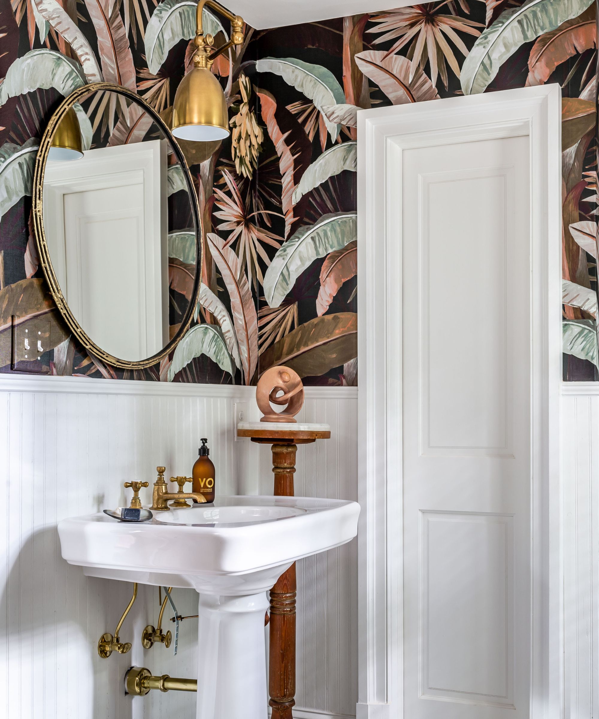Bathroom with Pure White paint by Sherwin-Williams and a bold botanical wallpaper